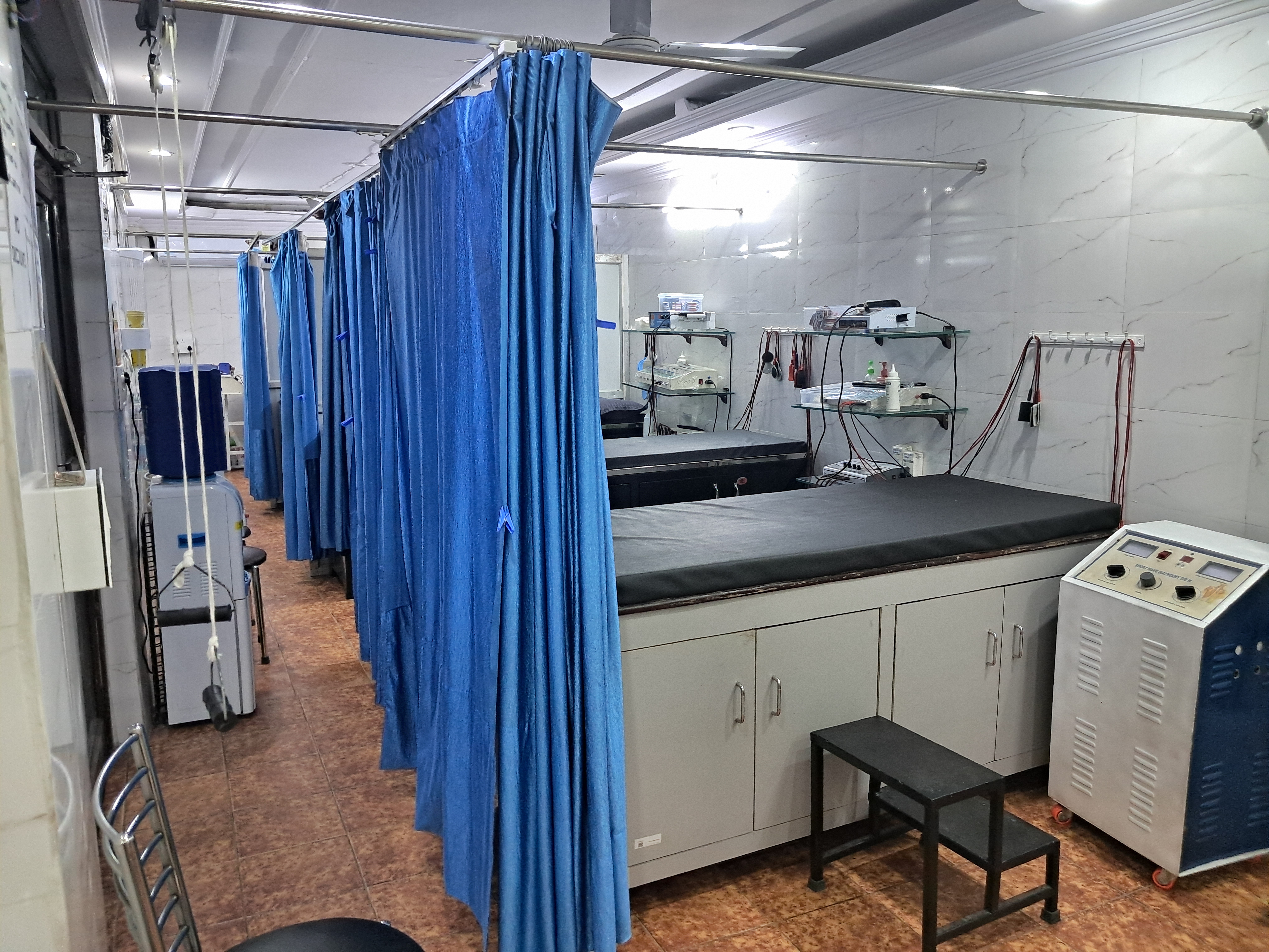 Clinic corridor with curtained treatment bays